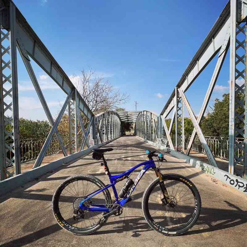 madrid_cycling_ A blue Orbea full suspension MTB at Puente de Arganda in Spain