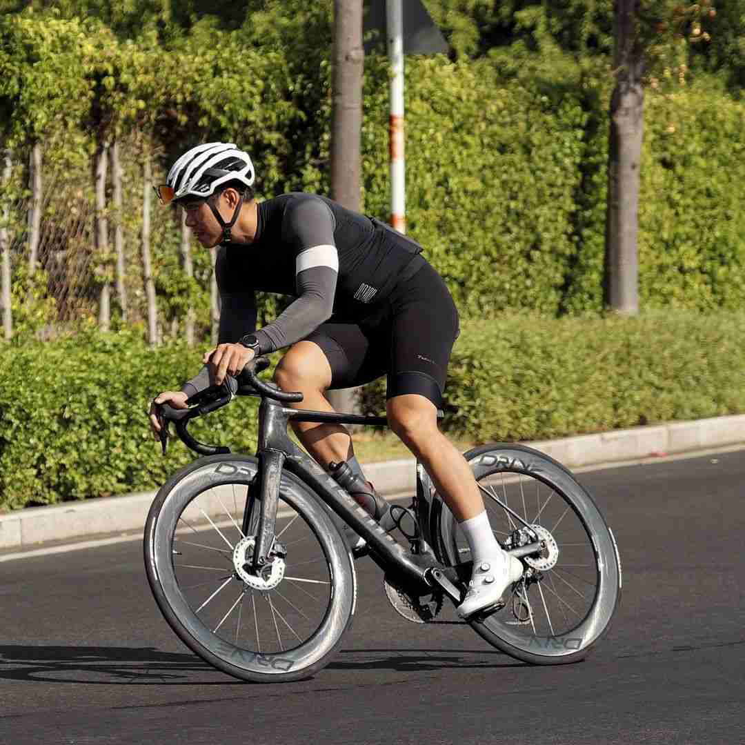A Cyclist Racing on a Factor Road Bike with Advanced Aerodynamic Wheelsets