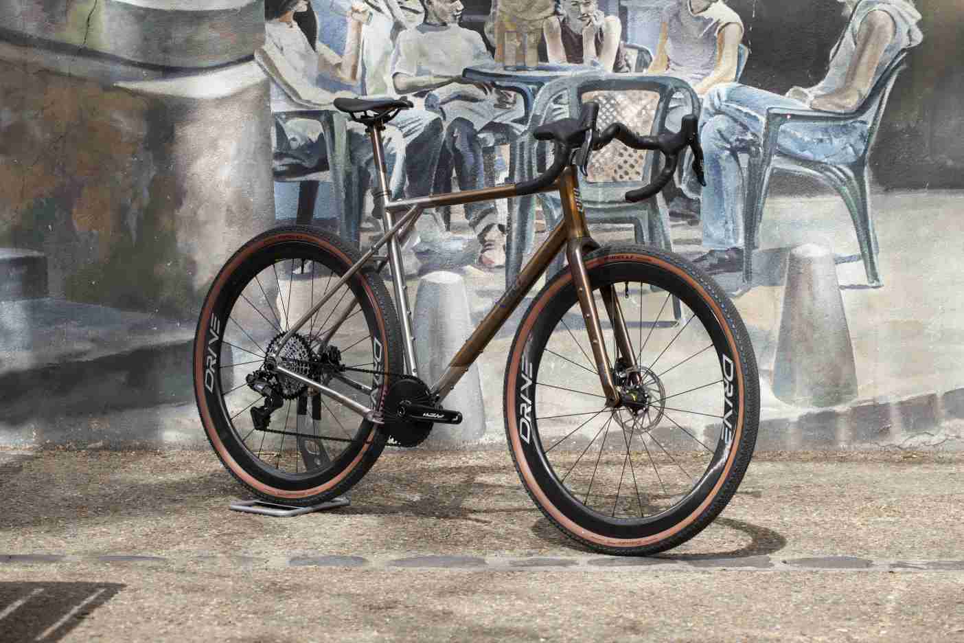 Titanium City Gravel Bike with Carbon Spoke Wheels on a French Street