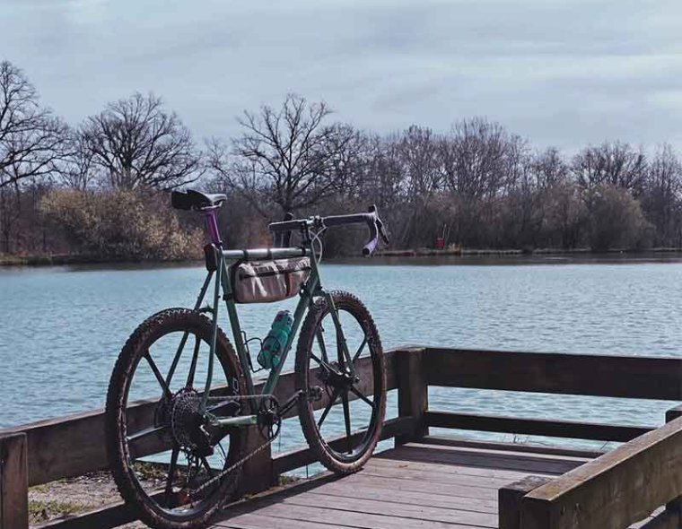 A green gravel bike with Drive Six-Gravel high-performance carbon fiber wheels on an endurance ride.
